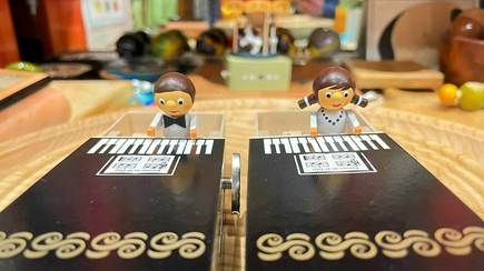 A couple of toy figurines on a table

Description automatically generated with low confidence